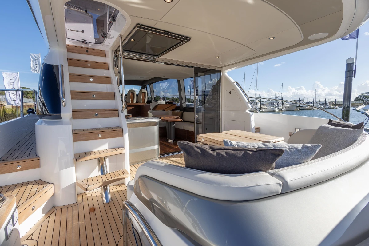 Luxurious 2025 Princess F58 yacht interior with elegant seating and wooden accents.