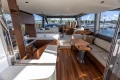 Luxurious interior of 2025 Princess F58 yacht with modern kitchen and seating area.