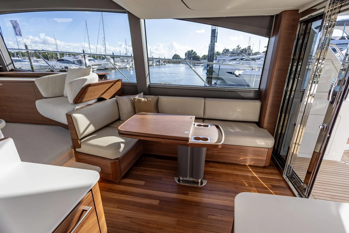 Luxurious interior of 2025 Princess F58 yacht with elegant seating and wooden finishes.