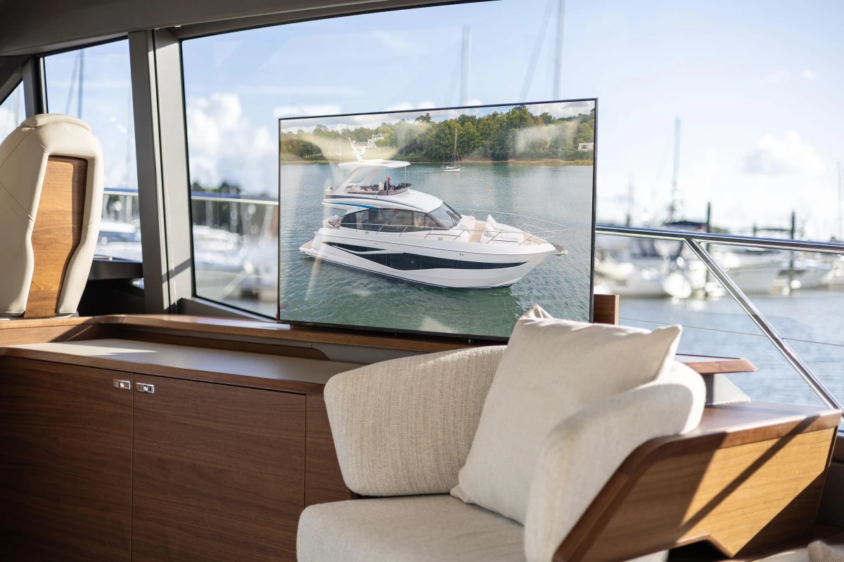 Luxurious interior of 2025 Princess F58 yacht with scenic marina view.