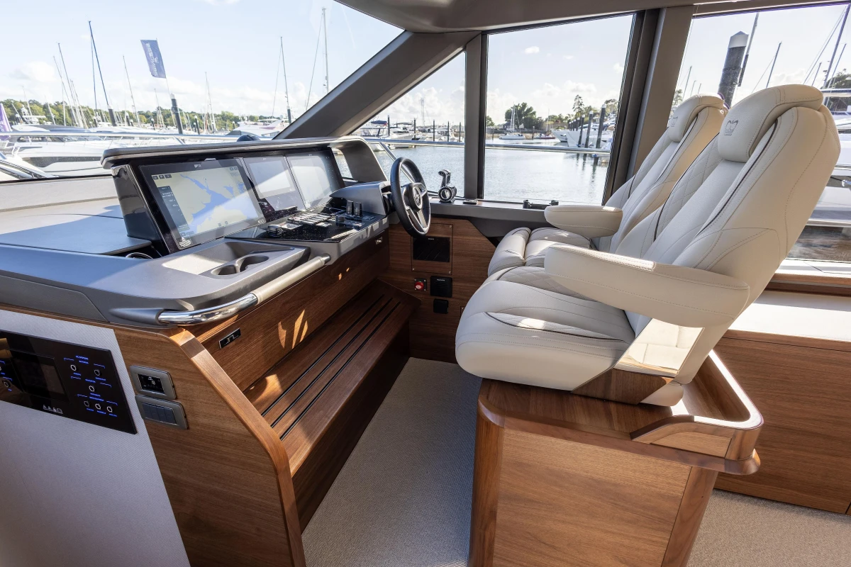 Luxurious 2025 Princess F58 yacht cockpit with modern navigation systems and plush seating.
