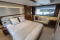 Luxurious bedroom interior of 2025 Princess F58 yacht with modern design and cozy seating.