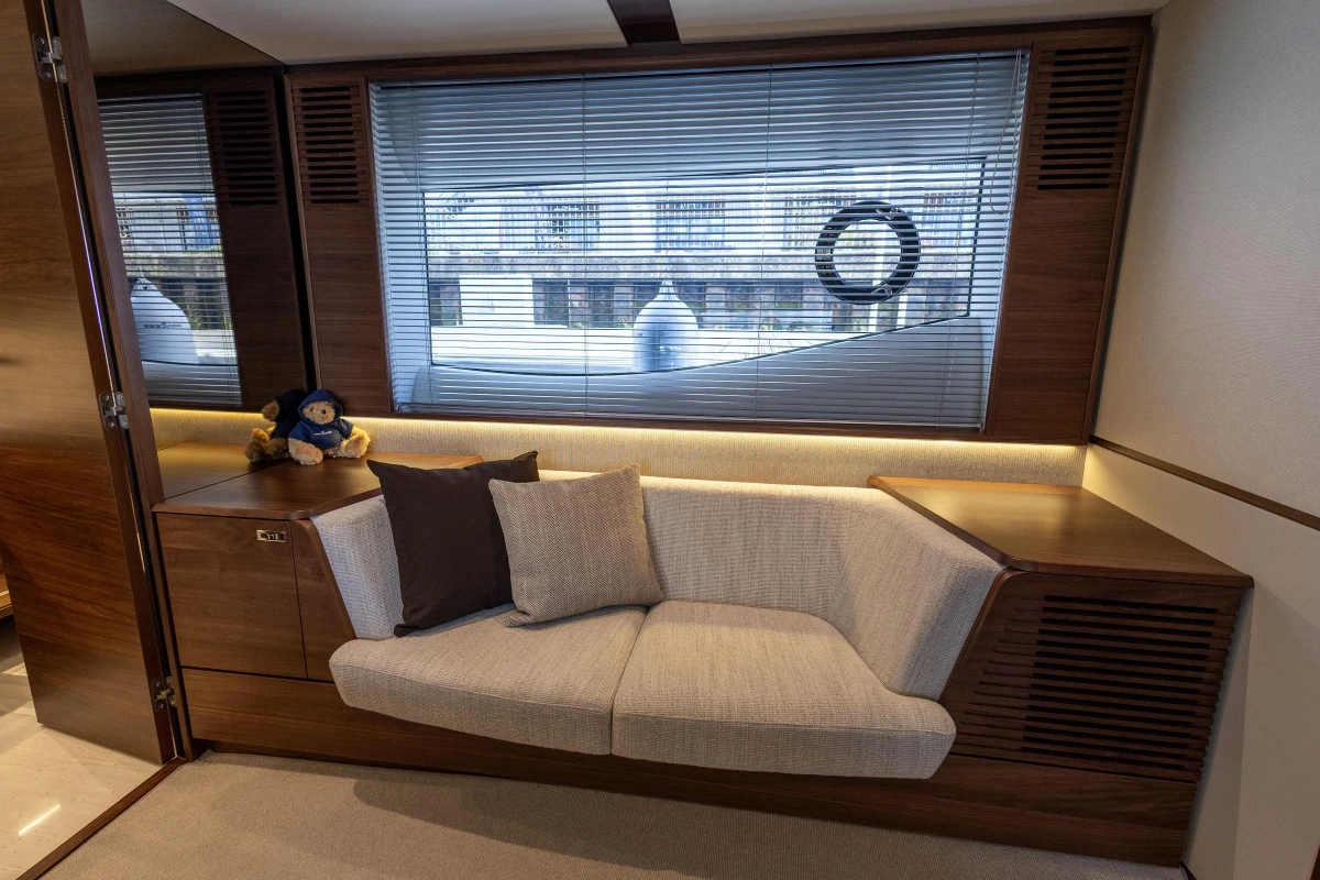 Luxurious interior of 2025 Princess F58 yacht with cozy seating and elegant wood finish.