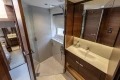 Luxurious bathroom interior of 2025 Princess F58 yacht, featuring modern fixtures and elegant wood finishes.