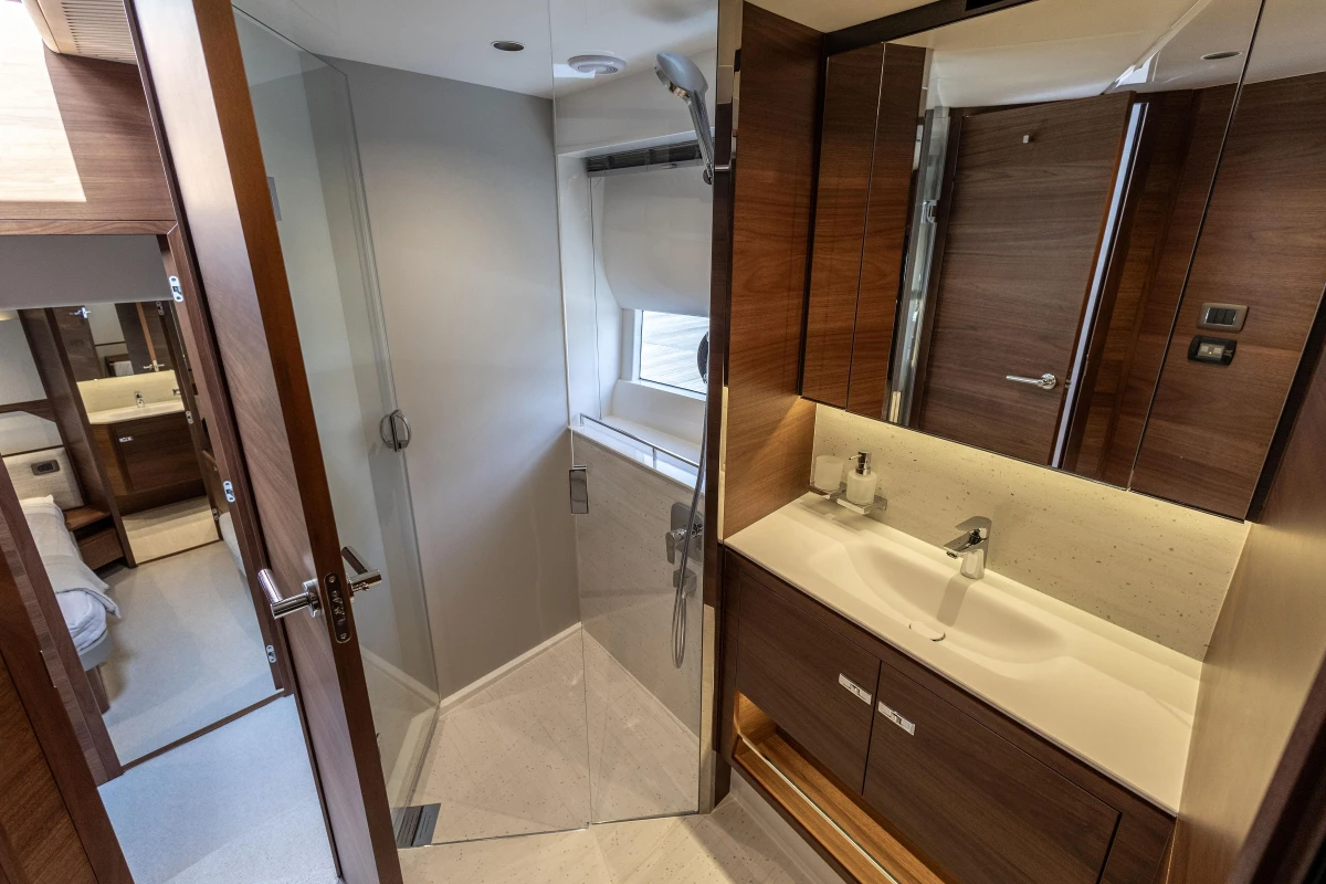 Luxurious bathroom interior of 2025 Princess F58 yacht, featuring modern fixtures and elegant wood finishes.