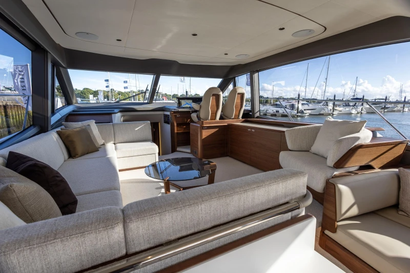 Luxurious interior of 2025 Princess F58 yacht with elegant seating and panoramic windows.