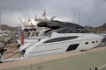 2017 Princess V48 Open yacht docked at a marina under cloudy skies.