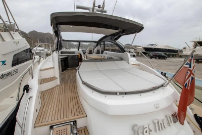 2017 Princess V48 Open yacht with spacious deck and elegant design in marina setting.