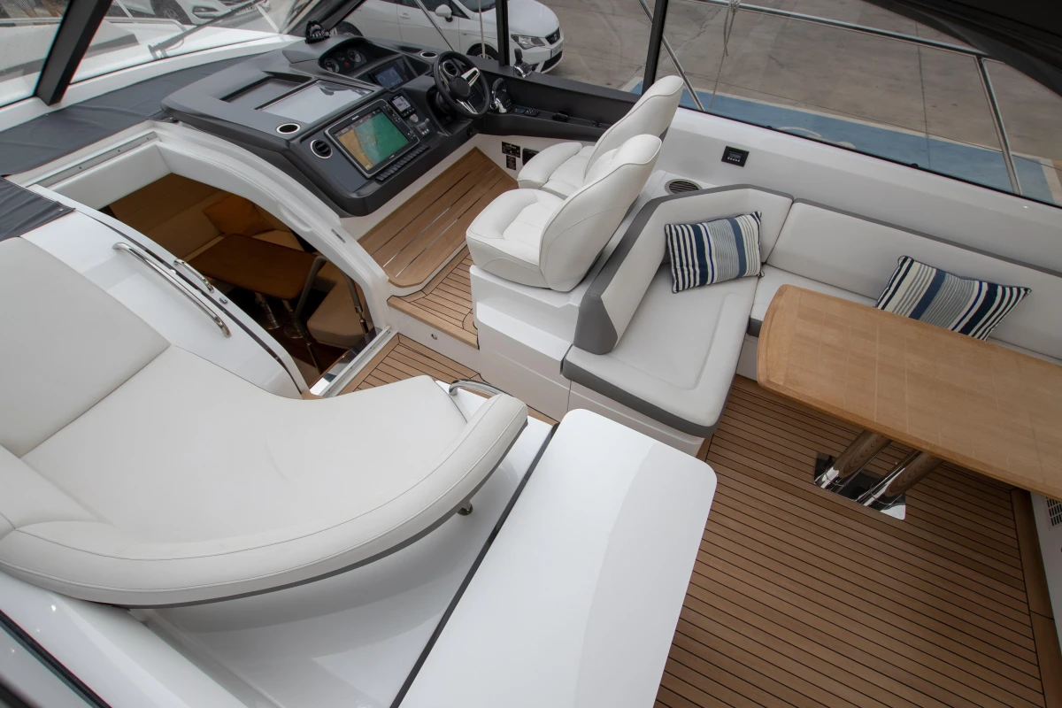 2017 Princess V48 Open yacht interior with plush seating and wooden flooring.