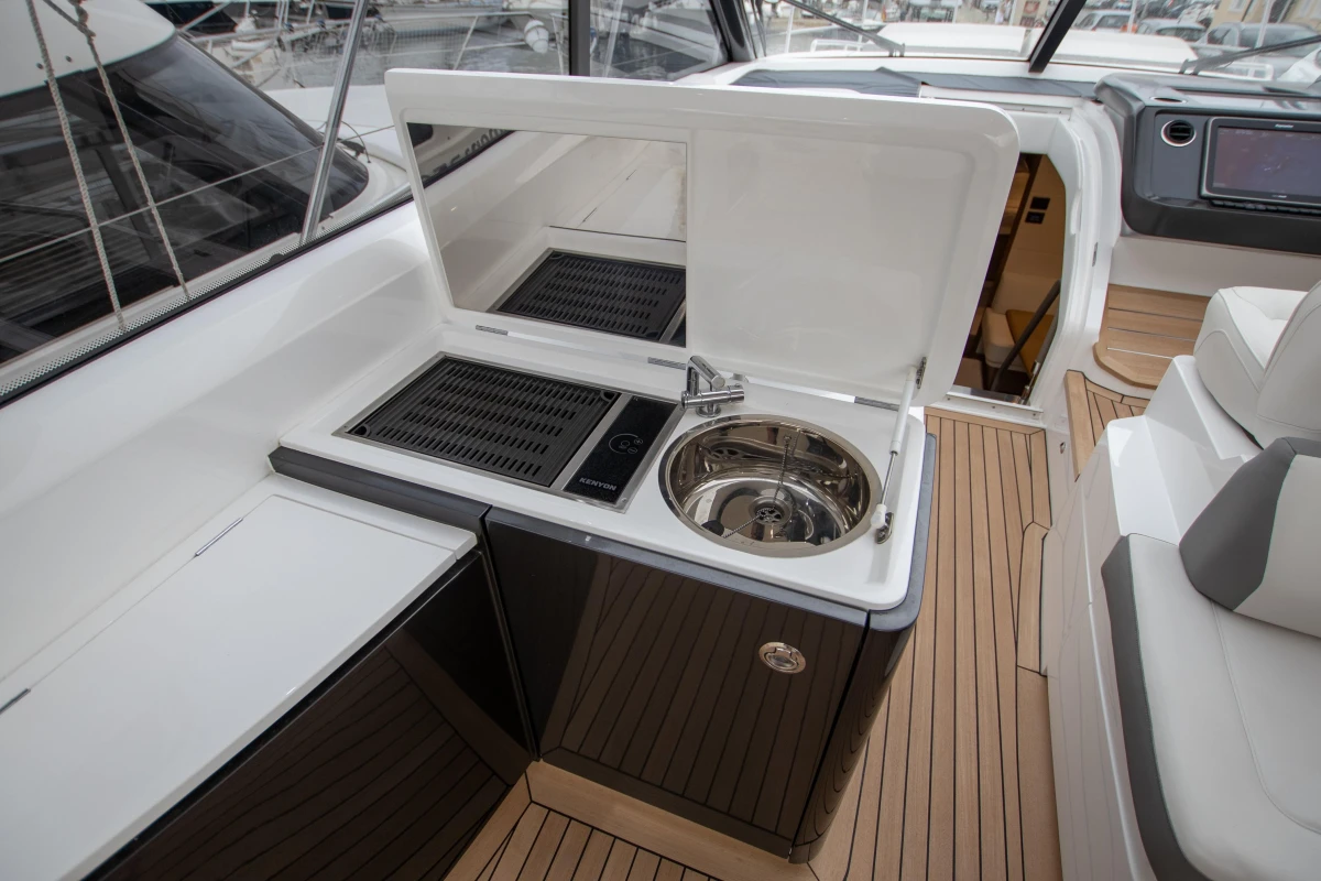 2017 Princess V48 Open yacht kitchenette with sink and grill on teak deck.