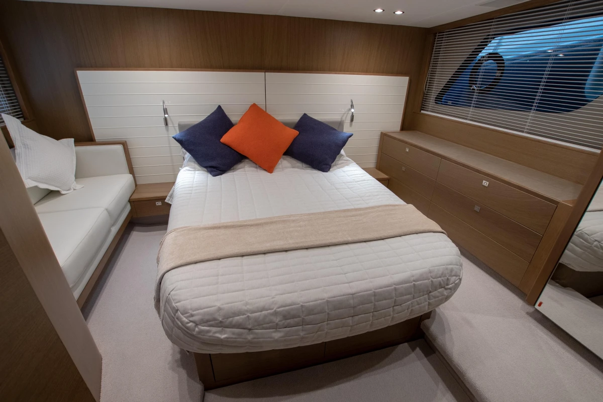 Luxurious bedroom interior of 2017 Princess V48 Open yacht with modern decor.