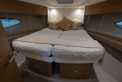 Luxurious cabin interior of 2017 Princess V48 Open yacht with cozy bedding and elegant design.