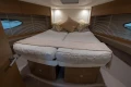 Luxurious cabin interior of 2017 Princess V48 Open yacht with cozy bedding and elegant design.