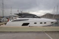 2017 Princess V48 Open yacht docked at a marina under cloudy skies.