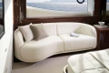 Luxurious interior of 2026 Princess X80 yacht with elegant white sofa and ocean view.