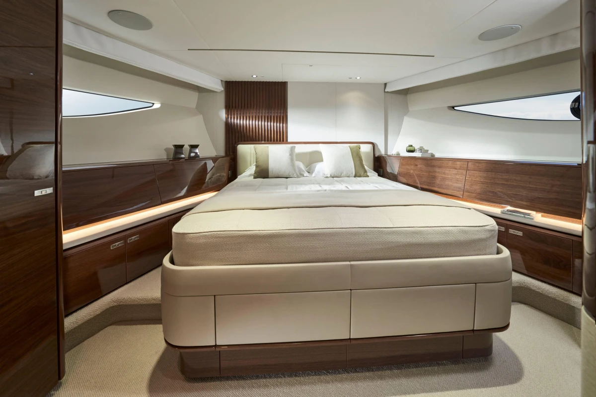 Luxurious bedroom interior of 2026 Princess X80 yacht with elegant wood finishes.