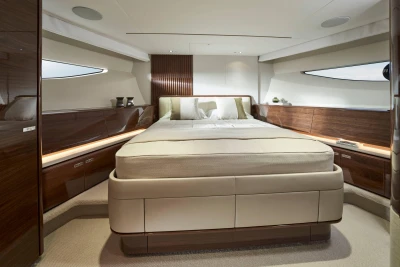 Luxurious bedroom interior of 2026 Princess X80 yacht with elegant wood finishes.