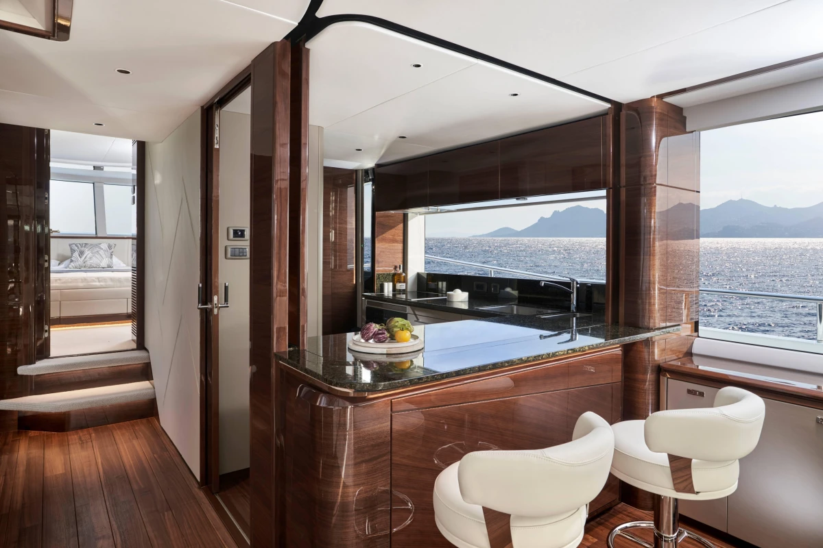 Luxurious interior of 2026 Princess X80 yacht with modern kitchen and ocean view.