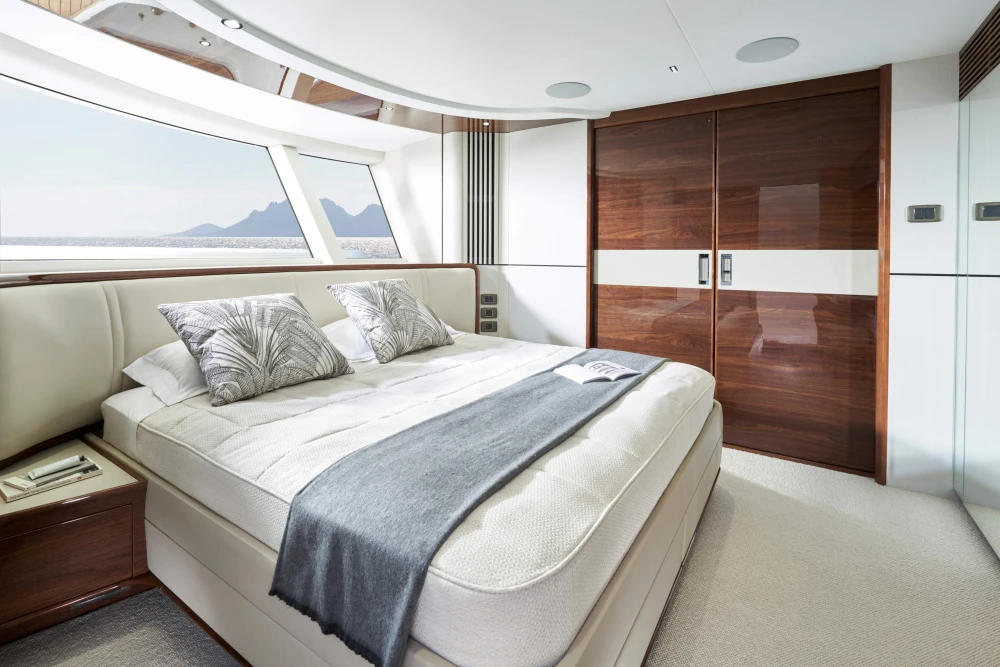 Luxurious bedroom interior of 2026 Princess X80 yacht with scenic ocean view.